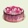Pink cream cake with smudges of chocolate on a white wooden background.